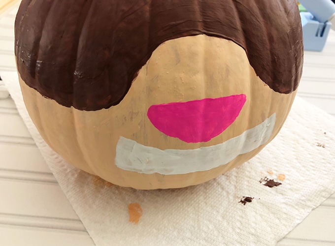 painting nose and mouth on pumpkin to make scaredy squirrel design