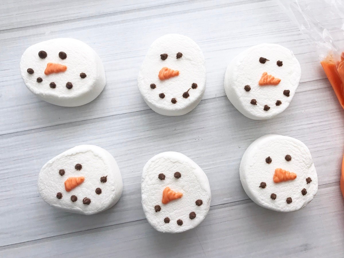 decorating snowman marshmallows with faces