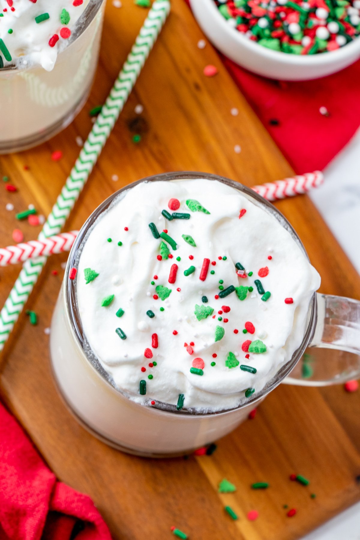 white hot chocolate, whipped topping, and candy sprinkles