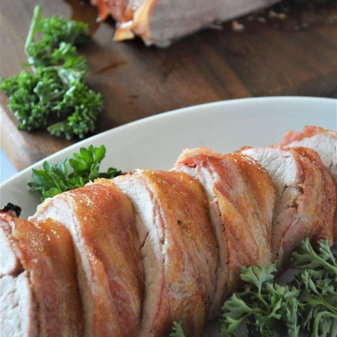 sliced Brown Sugar Bacon-Wrapped Pork Tenderloin on a platter