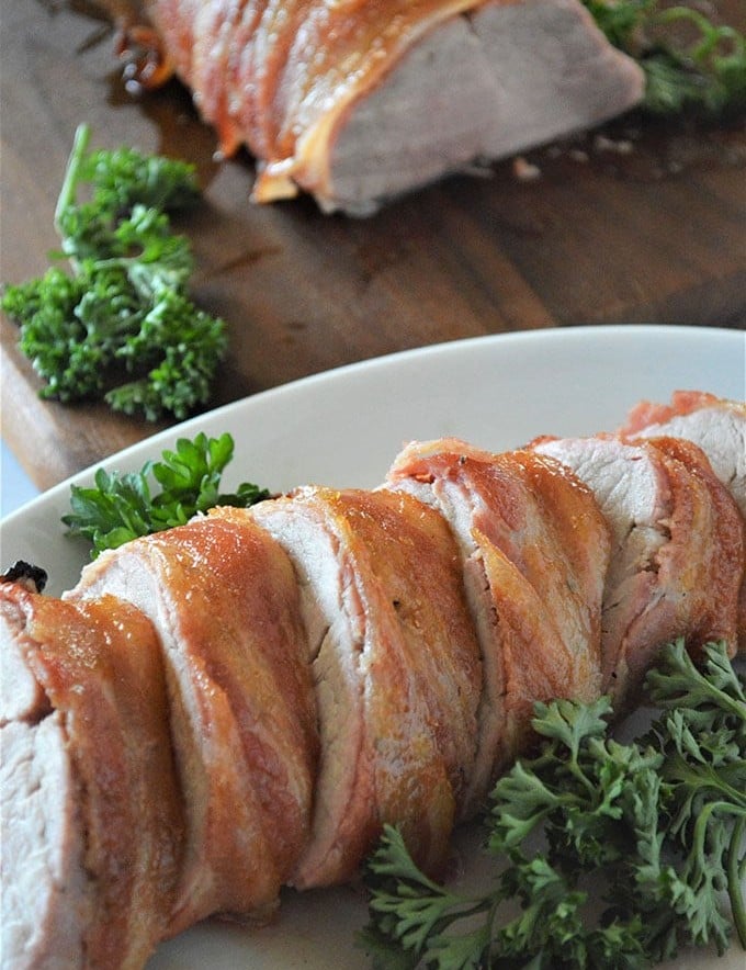 sliced Brown Sugar Bacon-Wrapped Pork Tenderloin on a platter
