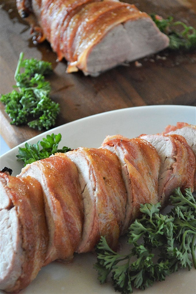 sliced Brown Sugar Bacon-Wrapped Pork Tenderloin on a platter