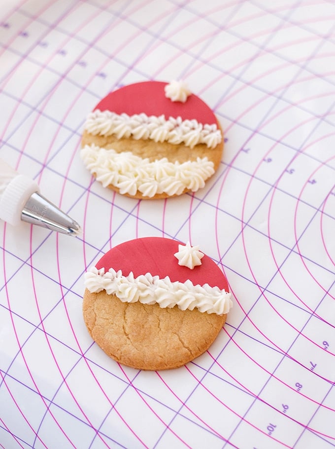 sugar cookie with red fondant and buttercream frosting to resemble santa's hat