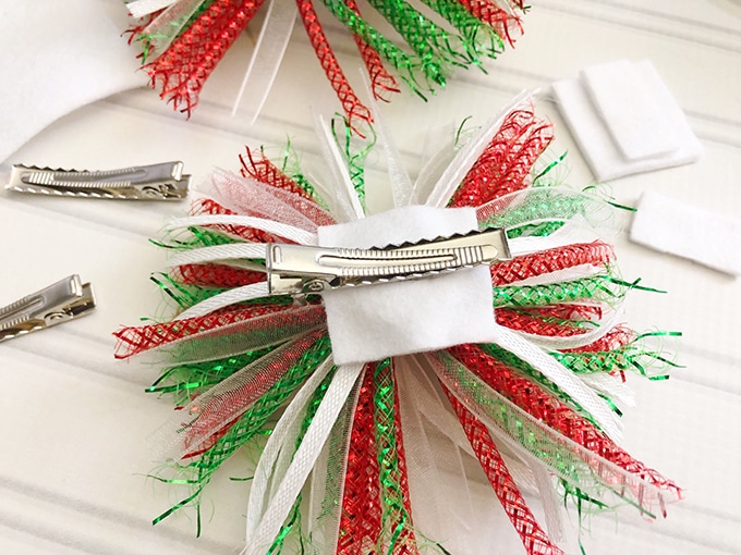 glue alligator clips on Christmas gift bows to make hair bows
