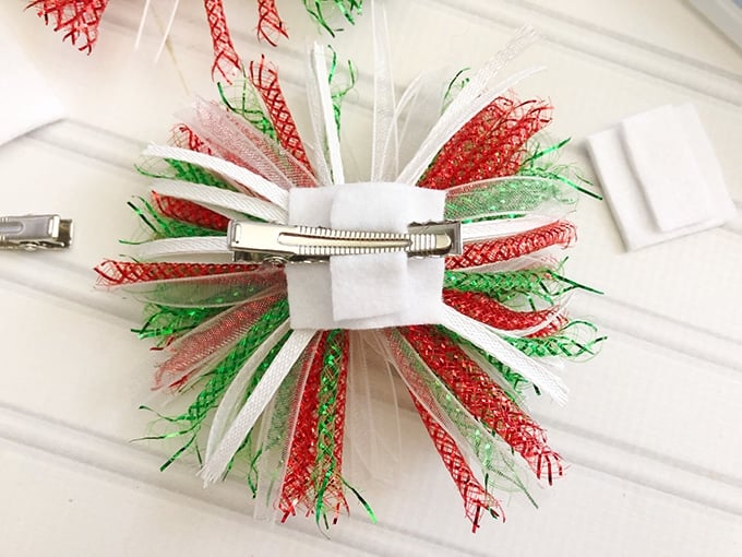 making Christmas hair bows with holiday gift bows, felt, and alligator clips