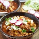 Pork Pozole Rojo with radish, cabbage,and onions in a bowl