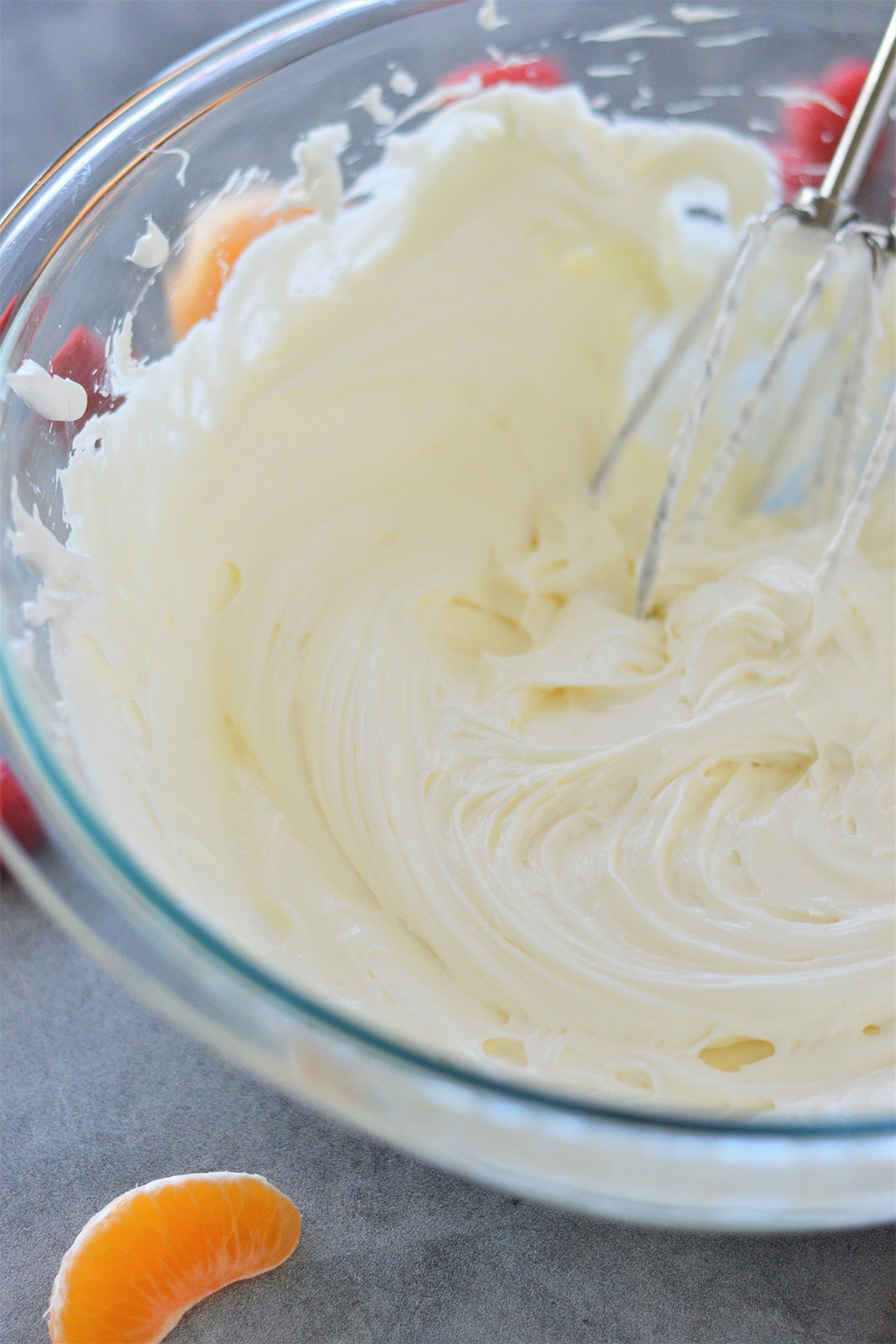 whipped cream cheese and marshmallow fluff in a clear glass bowl