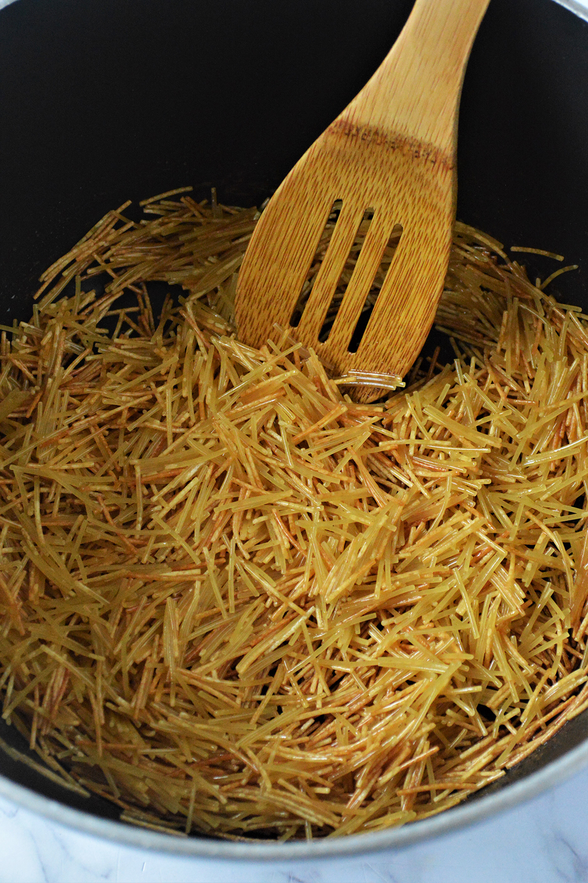 browning fideo noodles in a pan