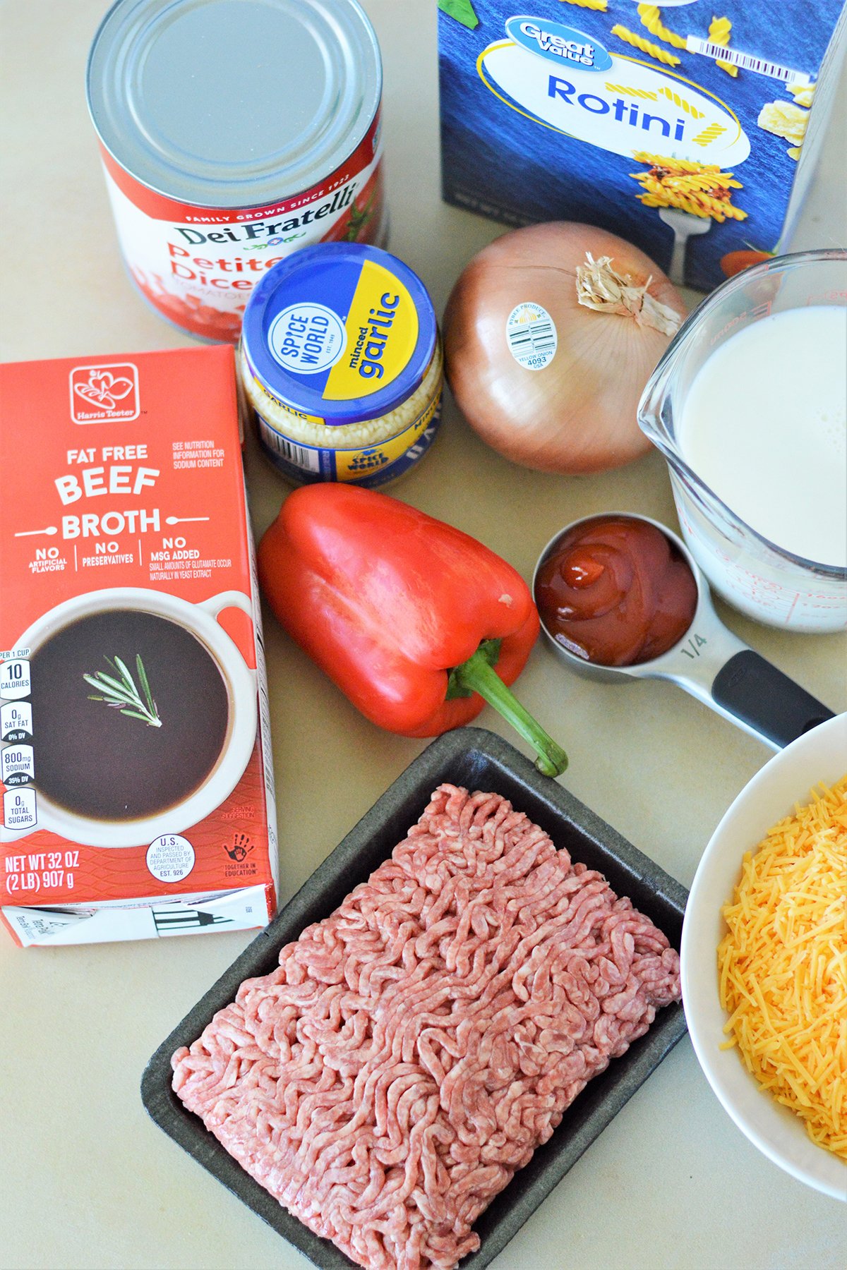 ground beef, rotini, crushed tomatoes, shreeded cheese, milk, ketchup, chopped onions, garlic