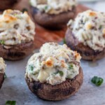 Bacon and Cream Cheese Stuffed Mushrooms on a serving board.