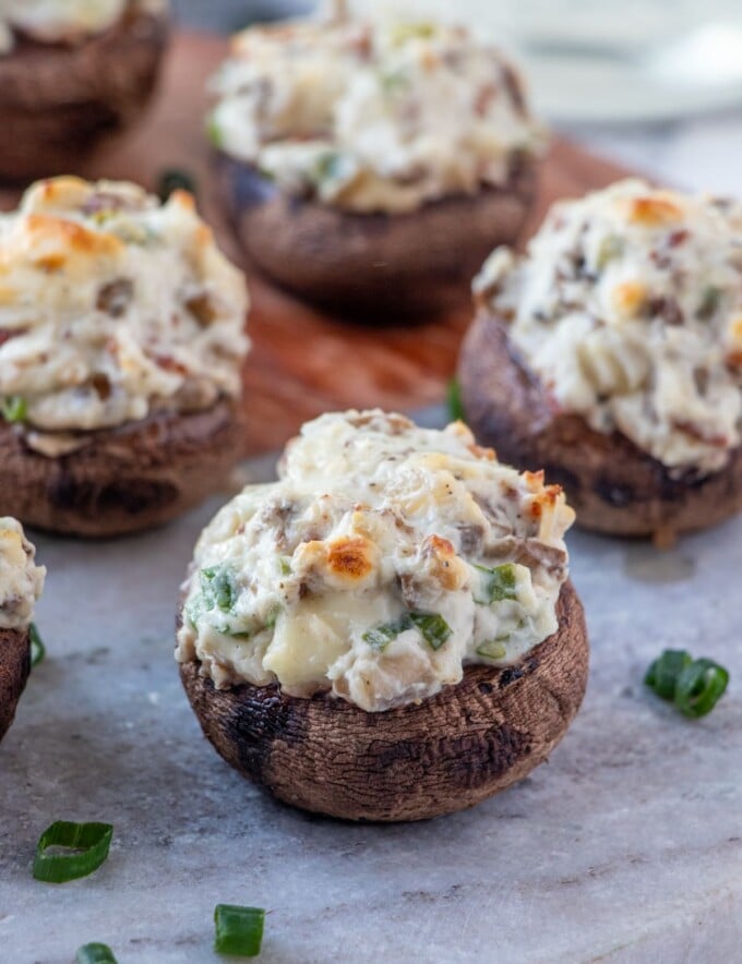 Bacon and Cream Cheese Stuffed Mushrooms on a serving board.