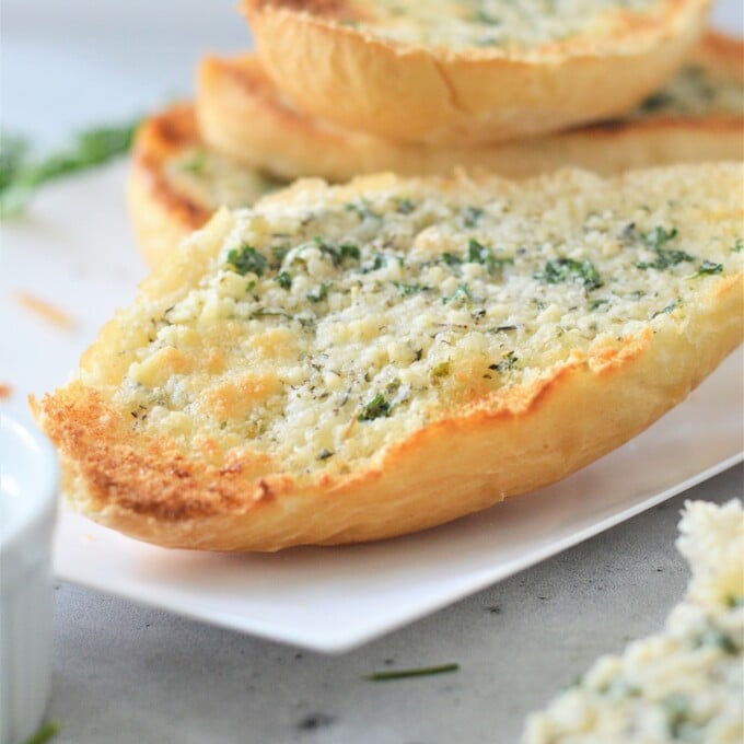 garlic bread on a white platter.