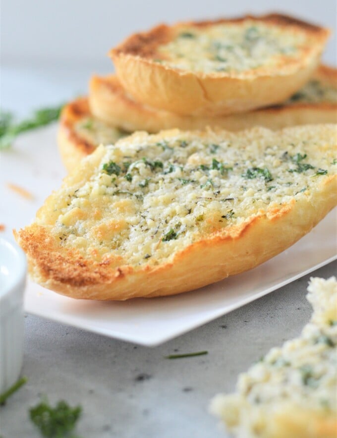 garlic bread on a white platter.